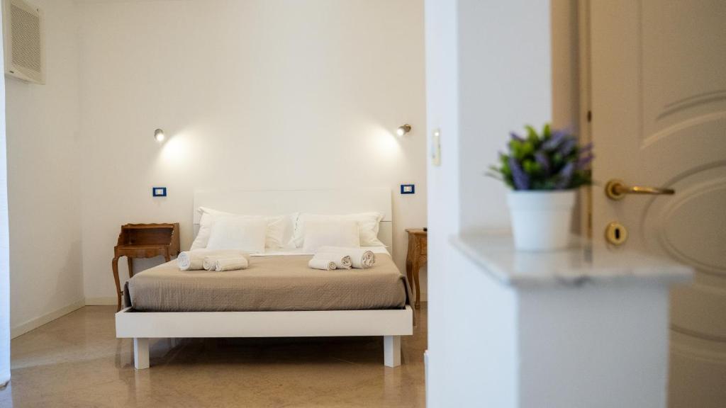 a bedroom with a bed with two towels on it at B&B Estea Tropea in Tropea