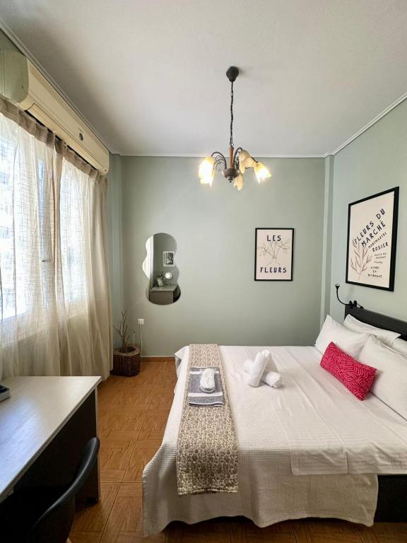 a bedroom with a bed with red pillows on it at Oscar - City Center Rooms Athens in Athens