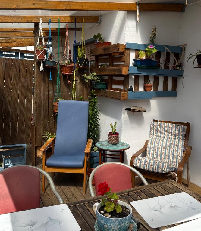 a living room with chairs and a table at Casa do Mar - Nazaré Big Wave Spotter House in Nazaré