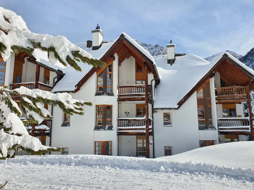 a building covered in snow with snow covered trees at Schweizerhof Drescher 612 in Lenzerheide
