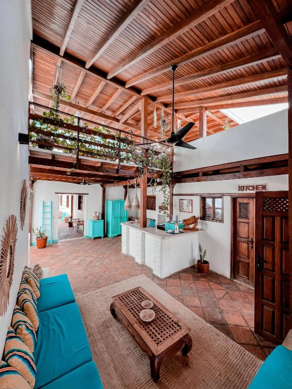 a living room with a blue couch and a table at Posada Casa Play Los Roques in El Roque