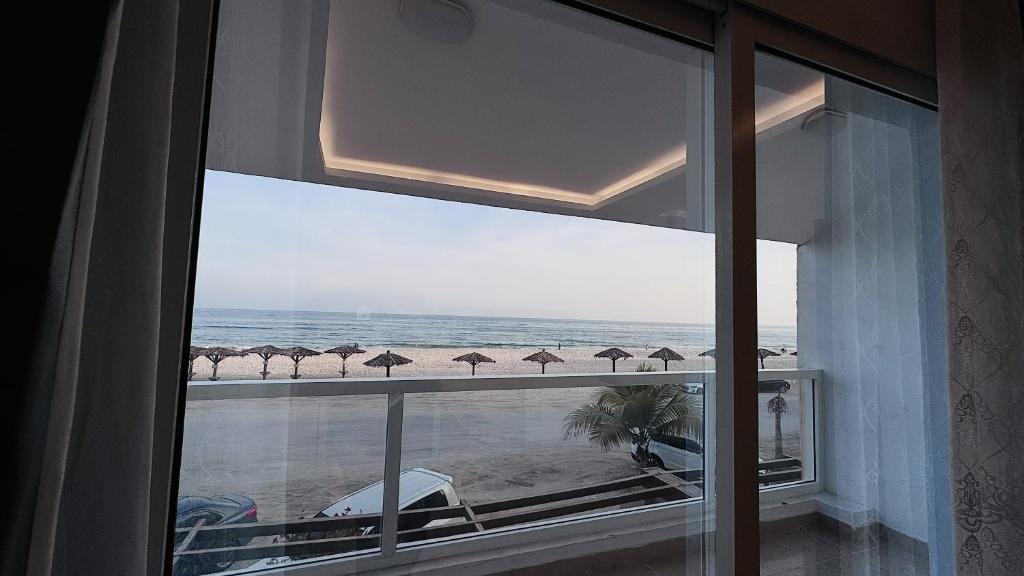 a view of the ocean from a room with a window at Family Beach Villas in Salalah