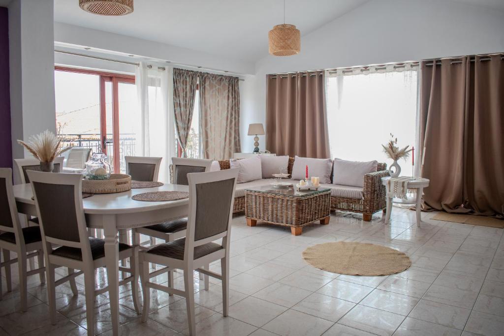 a living room with a couch and a table and chairs at Christina's Home in Skiathos