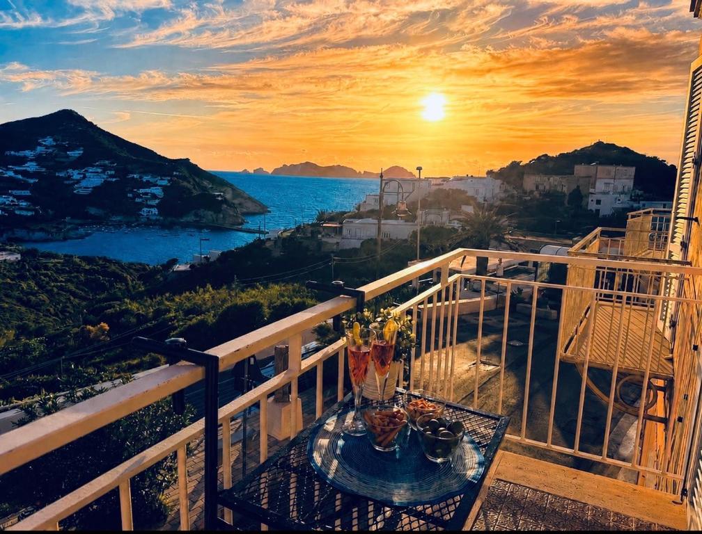 a table on a balcony with a view of the ocean at Ponzamania Bacio Del Sole in Ponza