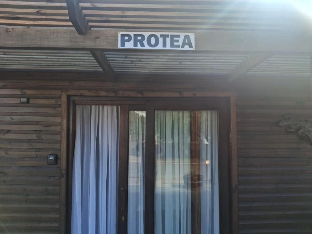 a sign above a door of a building at Protea in Britannia Bay