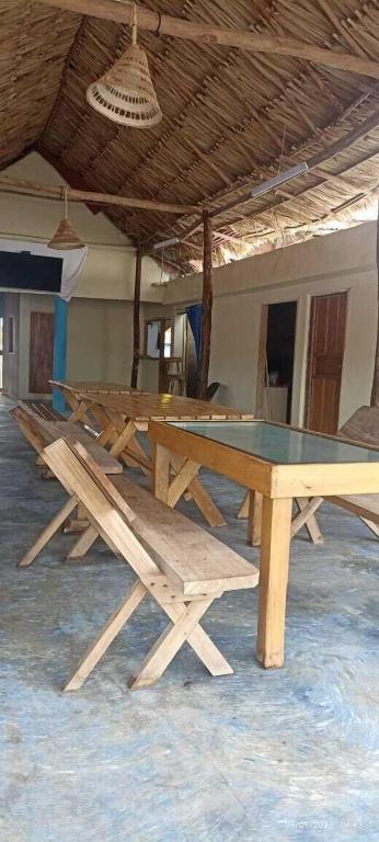 a group of picnic tables with a ping pong table at Hotel Y Restaurante Verano Azul in Moñitos