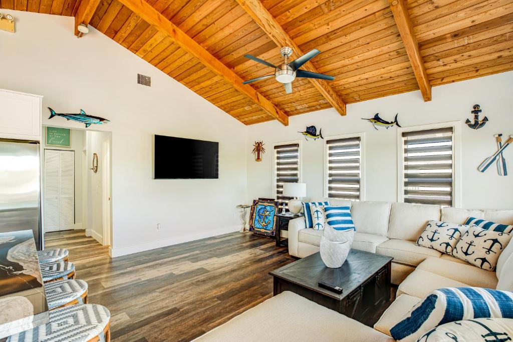 a living room with a couch and a tv at BP05FLR Tradewinds Treat in Big Pine Key