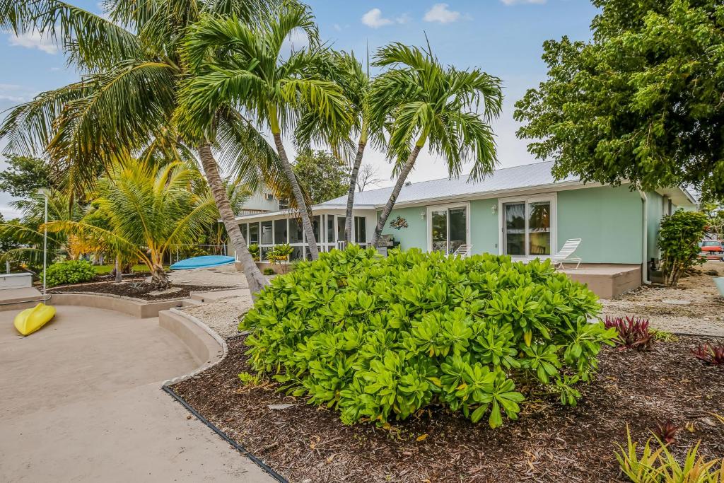a house with palm trees in front of it at BC277FLR Sapphire Sabbatical in Key West
