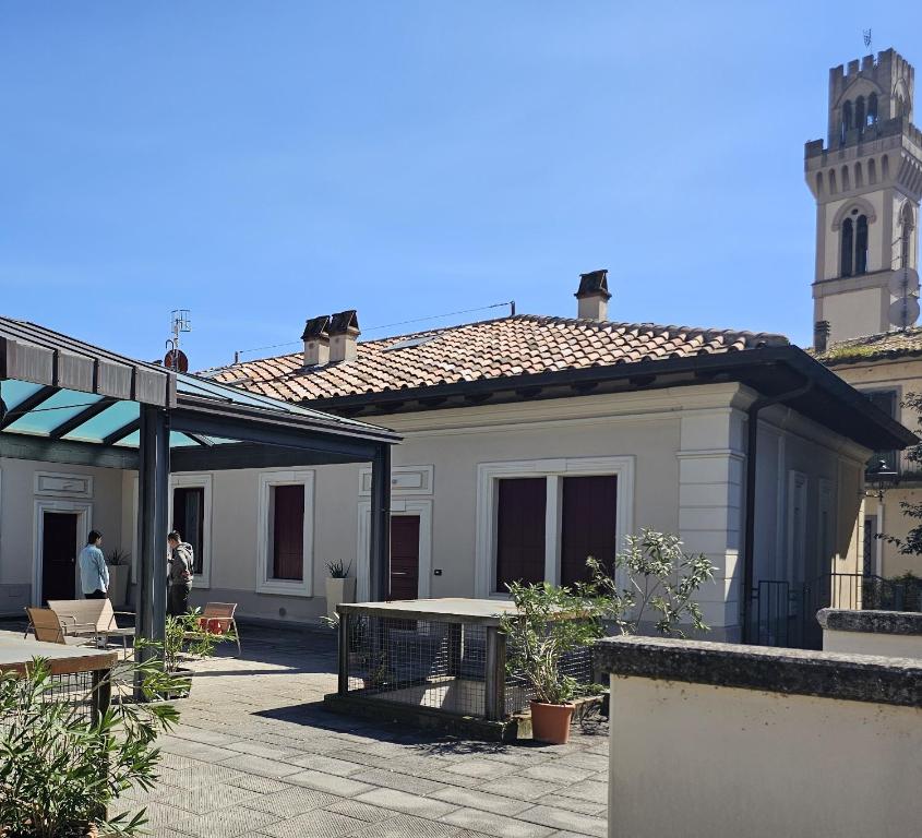 a large white building with a clock tower in the background at Camere AL Borgo in Santa Sofia