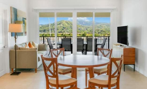a living room with a table and chairs and a couch at Luxury Marina Suite 2BR in Playa Flamingo