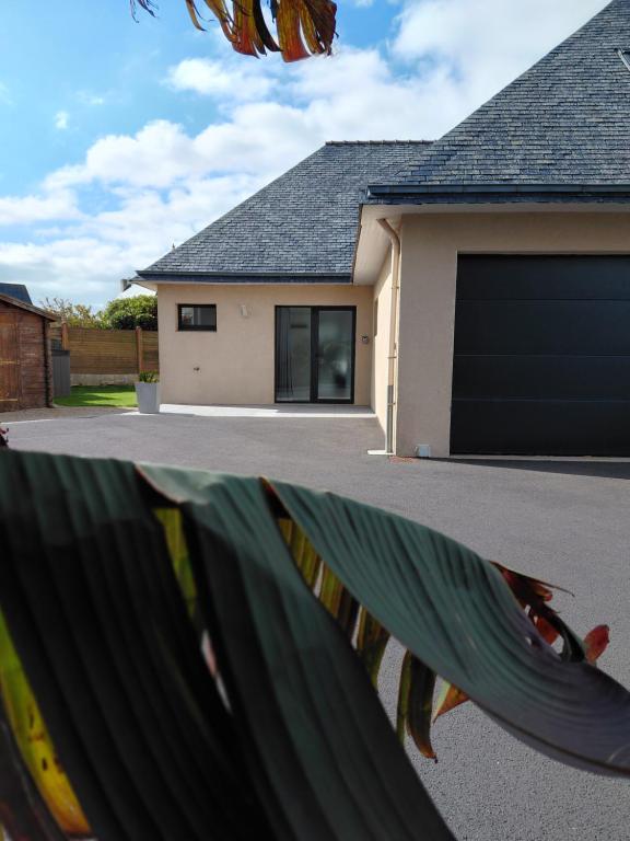 a house with a garage door and a house at Maison à 2 pas des plages in Roscoff