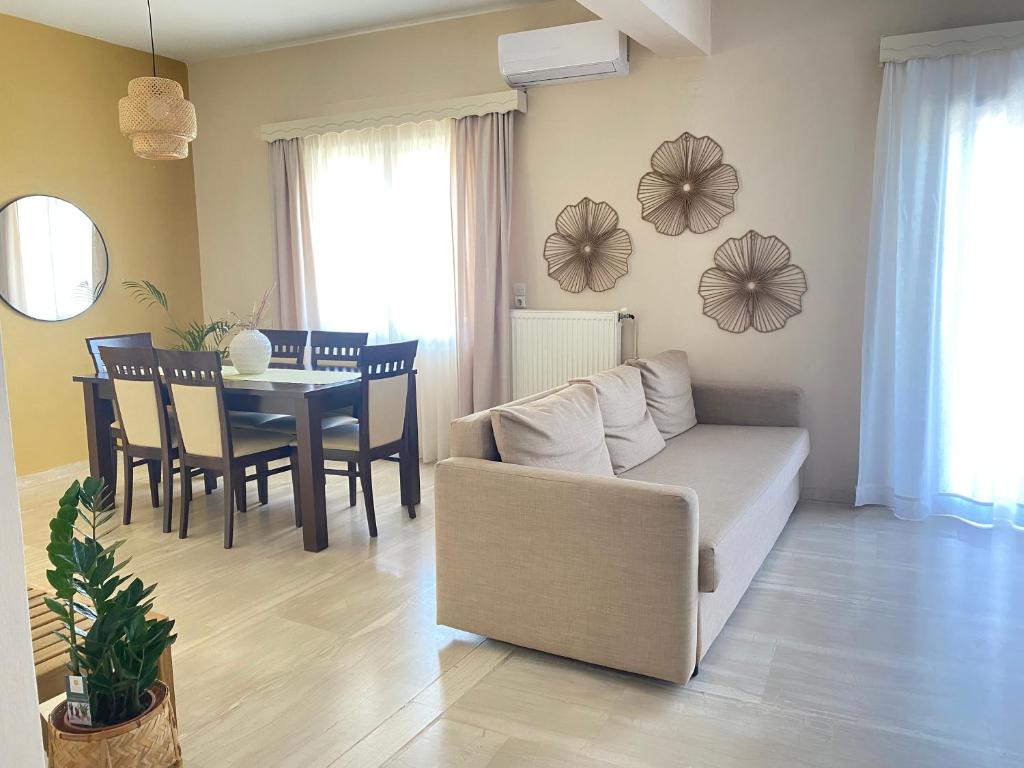 a living room with a couch and a table at 70 sqm sea view apartment in Parga
