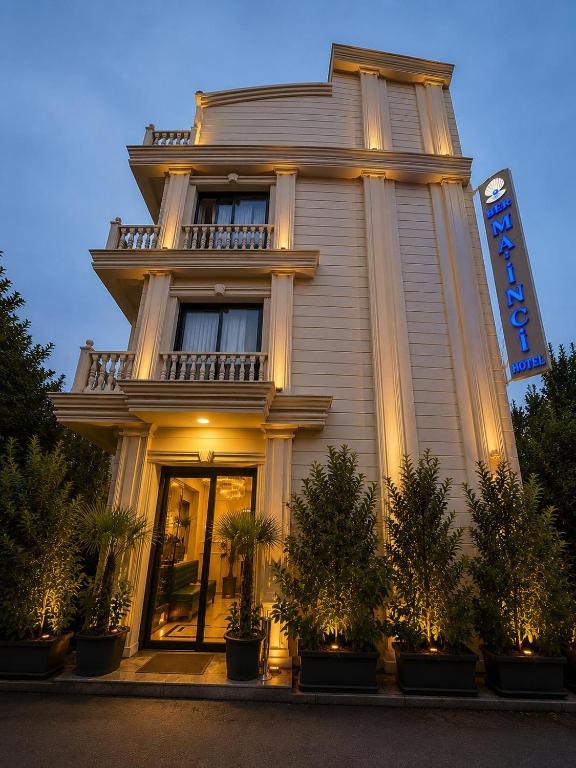 a building with a sign on the side of it at Ber Mai İnci Hotel Antalya in Antalya