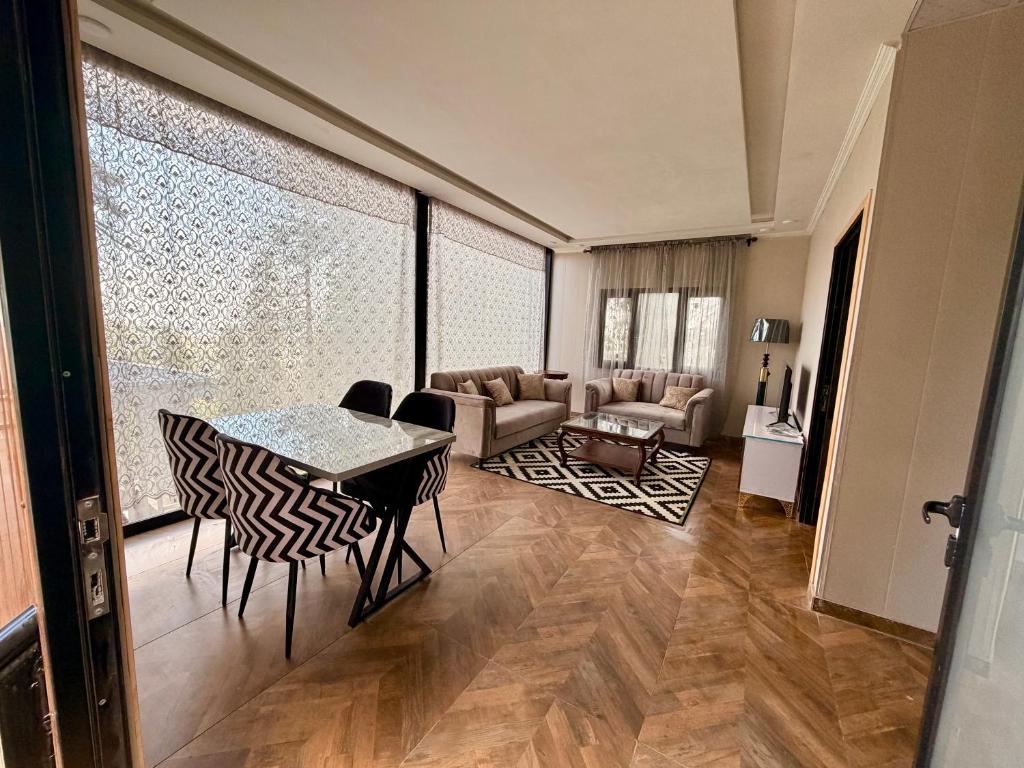 a living room with a table and chairs at The Pinecrest in Nathia Gali