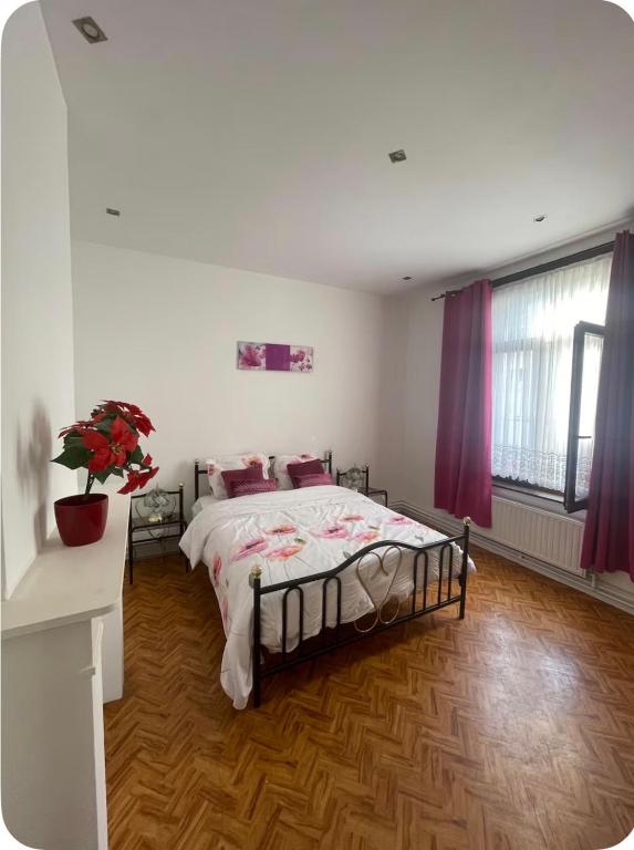 a bedroom with a large bed with purple curtains at Grace Family Home in Brussels