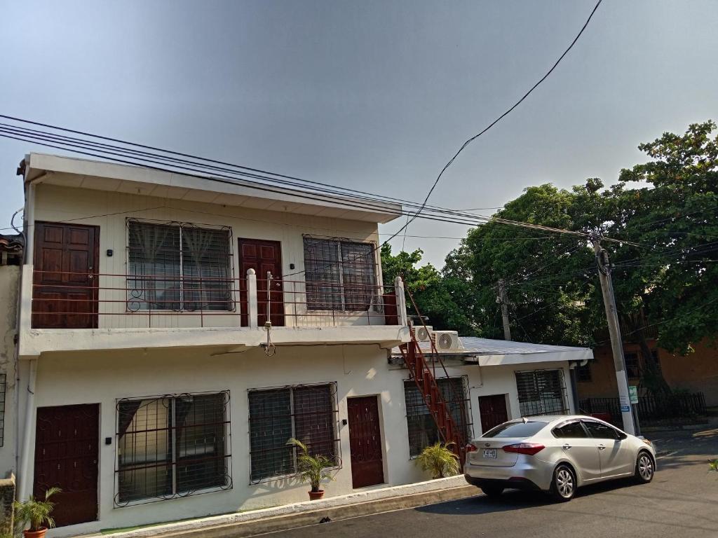 a white car parked in front of a house at Zacatecoluca House 2 in Zacatecoluca