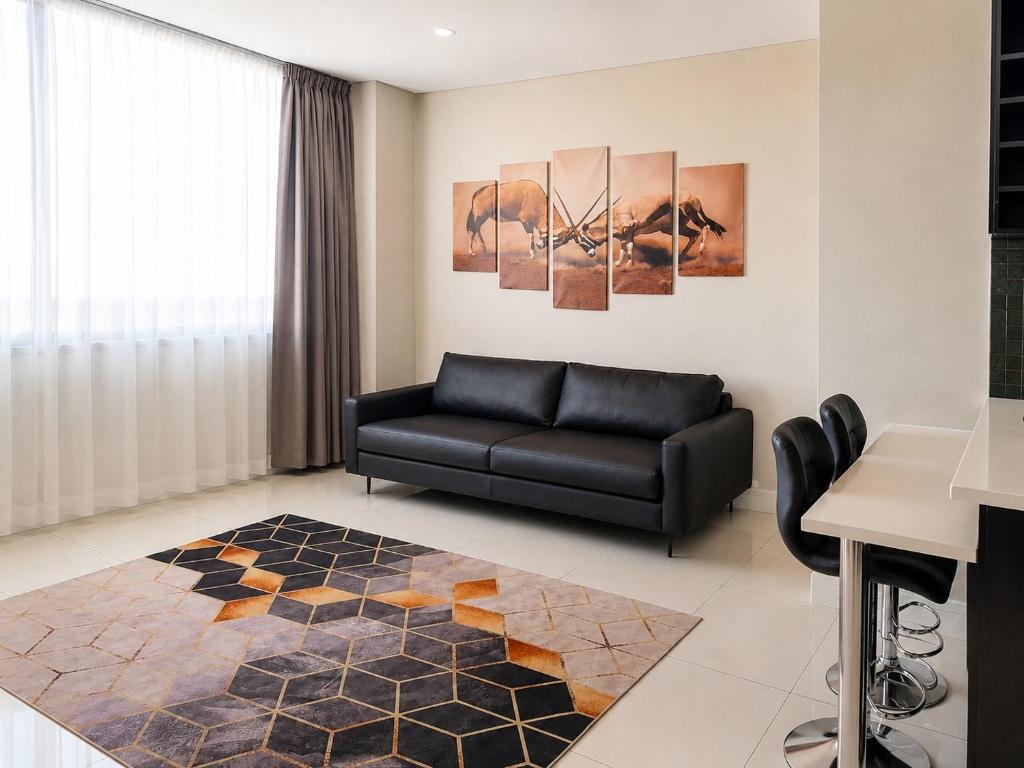 a living room with a couch and a table at Movic's Modern Airbnb in Windhoek