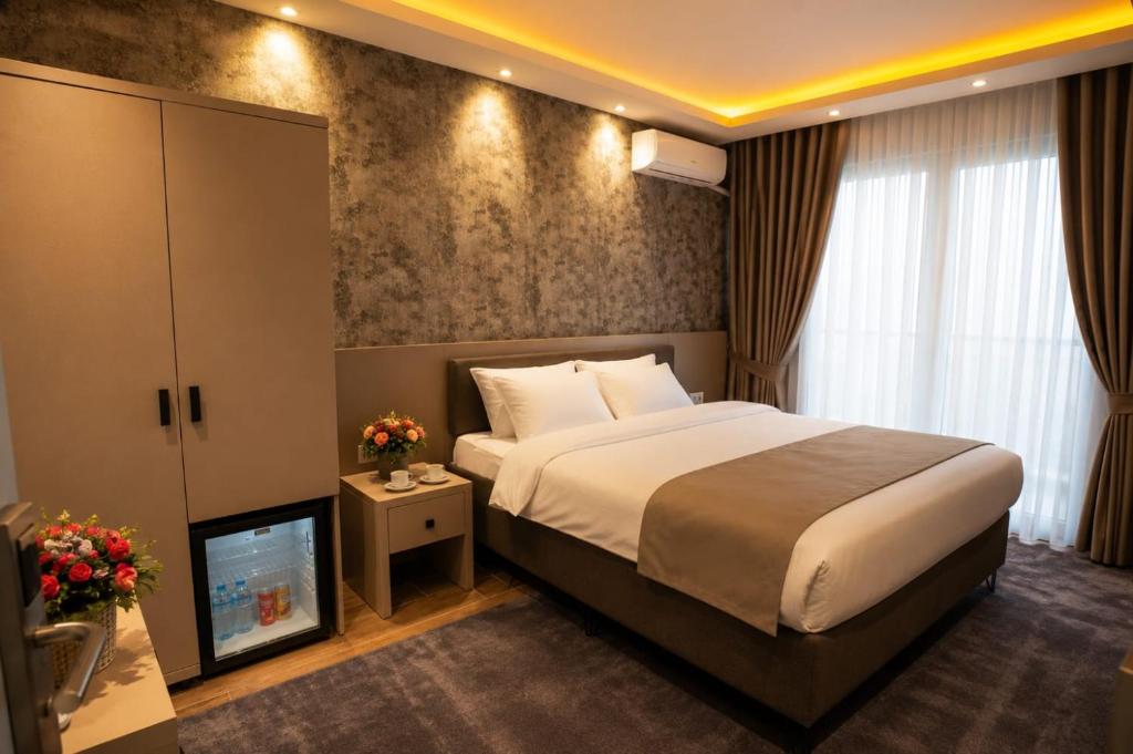 a hotel room with a bed and a television at Huzur Apart Hotel in Istanbul