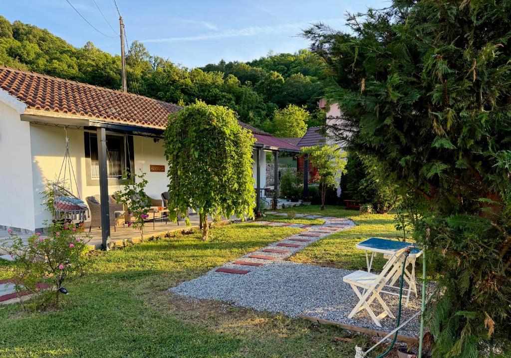 a house with a yard with a table and chairs at Sunlight Cottage Maya in Virpazar