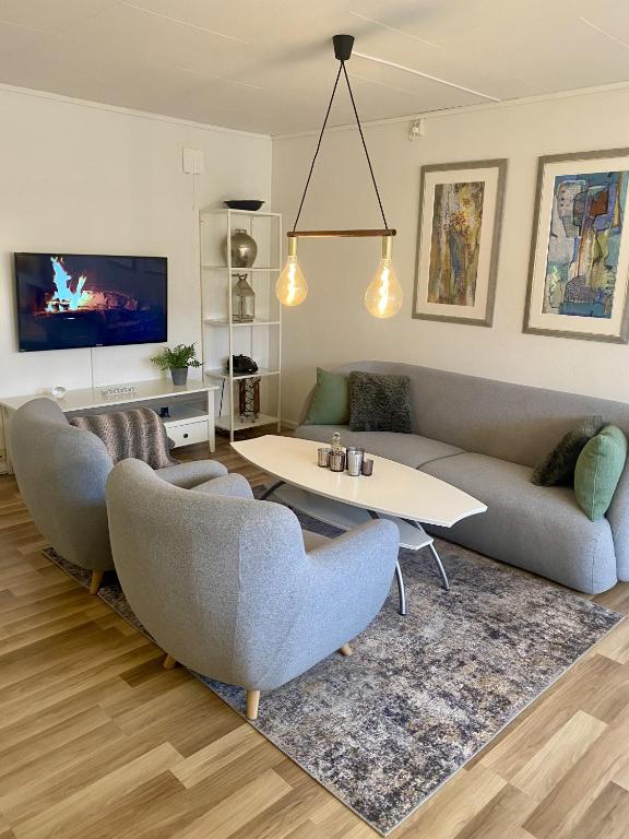 a living room with two couches and a table at Apartment Mandal in Mandal