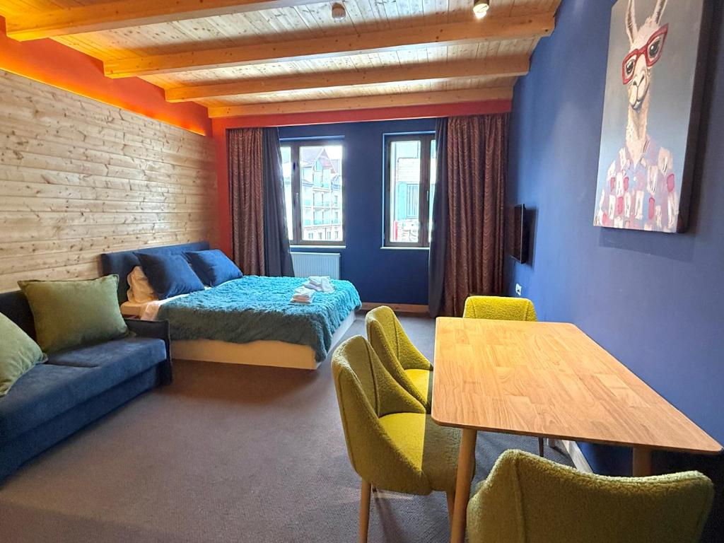 a room with a bed and a couch and a table at New Gudauri Studio N207 in Suites! in Gudauri