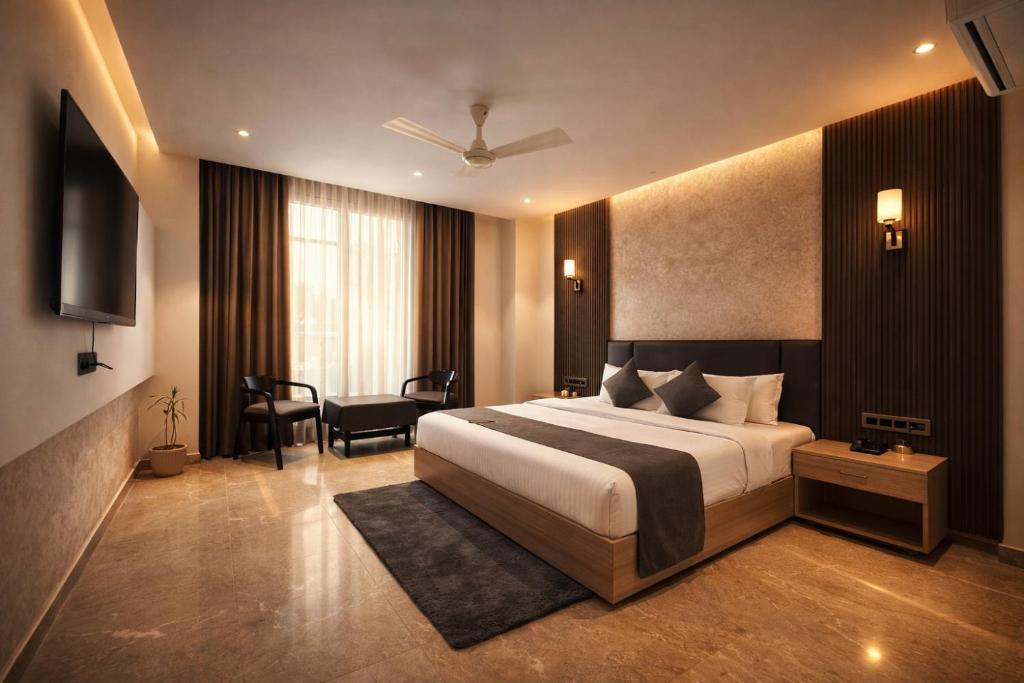 a hotel room with a bed and a television at Hotel Sunshine in Surajpur Jikkla