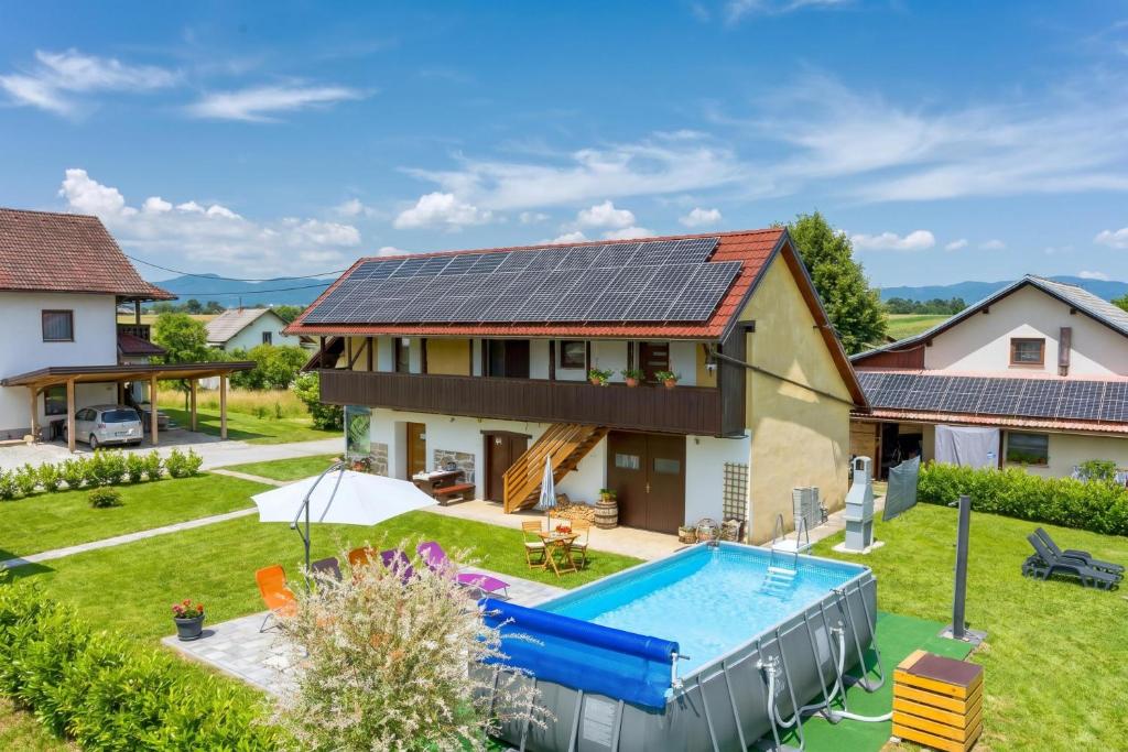 an image of a house with solar panels on the roof at Merry's House w/ Pool, Sauna & Jacuzzi - Happy Rentals in Griblje