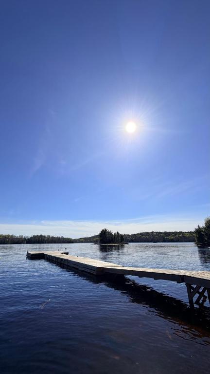 a dock in the middle of a body of water at Le Shack du Nord in Mont-Laurier