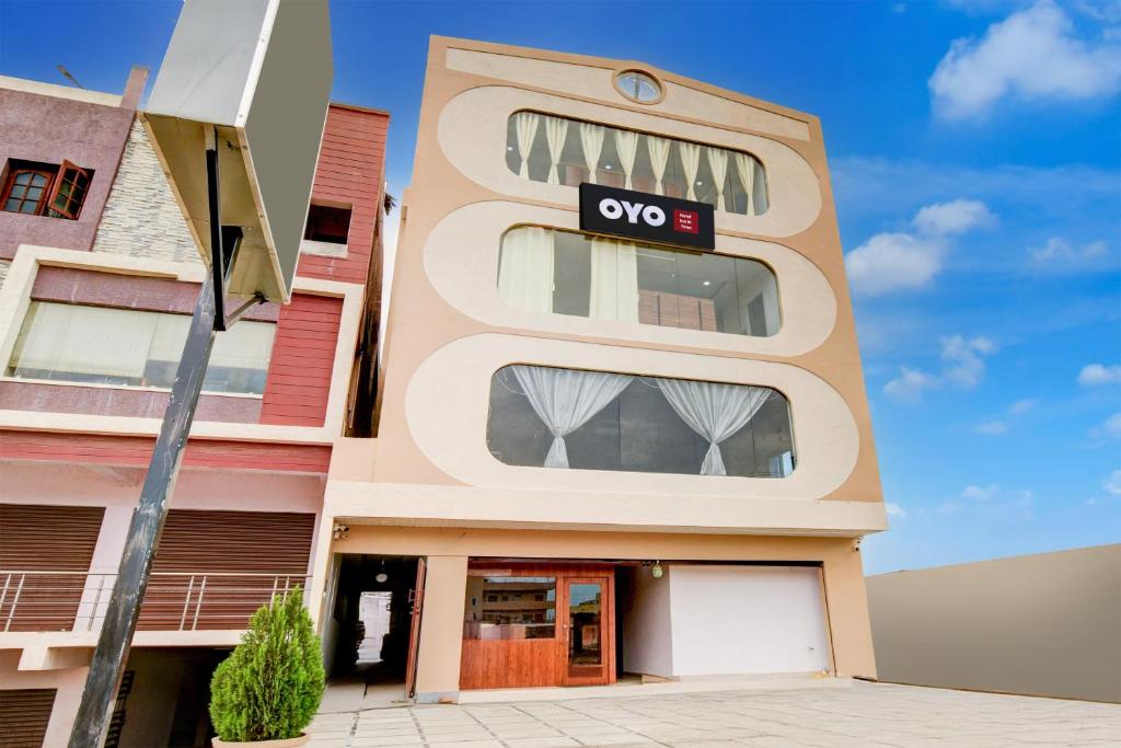 a building with aoops sign on the side of it at Hotel O Inn In Town in Sangāreddi