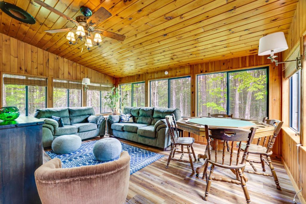 a living room with a couch and a table at Peaceful Wooded Retreat at Lake Wallenpaupack! in Lake Ariel