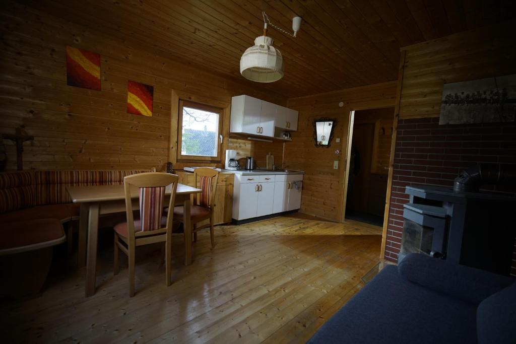 a kitchen with a table and chairs in a room at Camp Sibley Hütte in Oberdambach