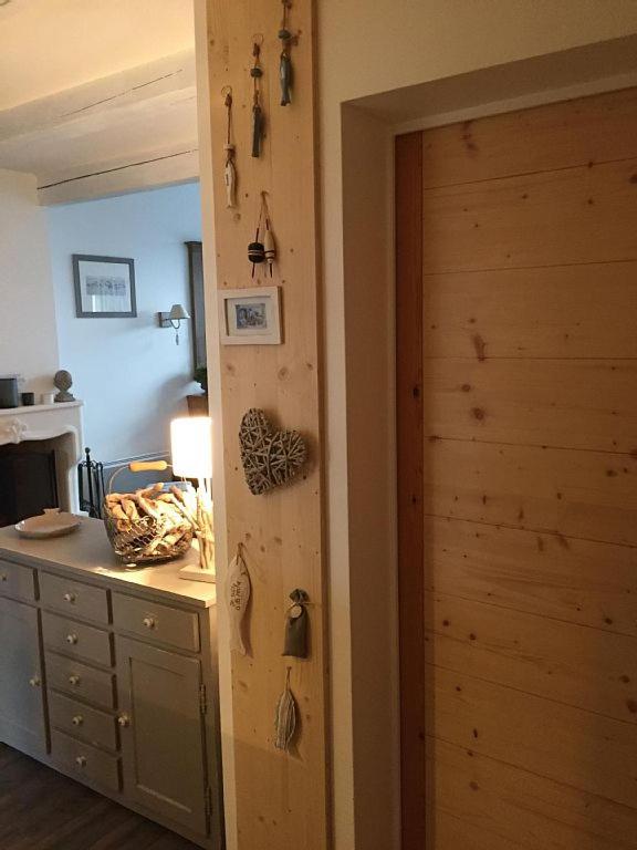 a room with a wooden door and a desk at Villa Pigouille in Sainte-Marie-de-Ré
