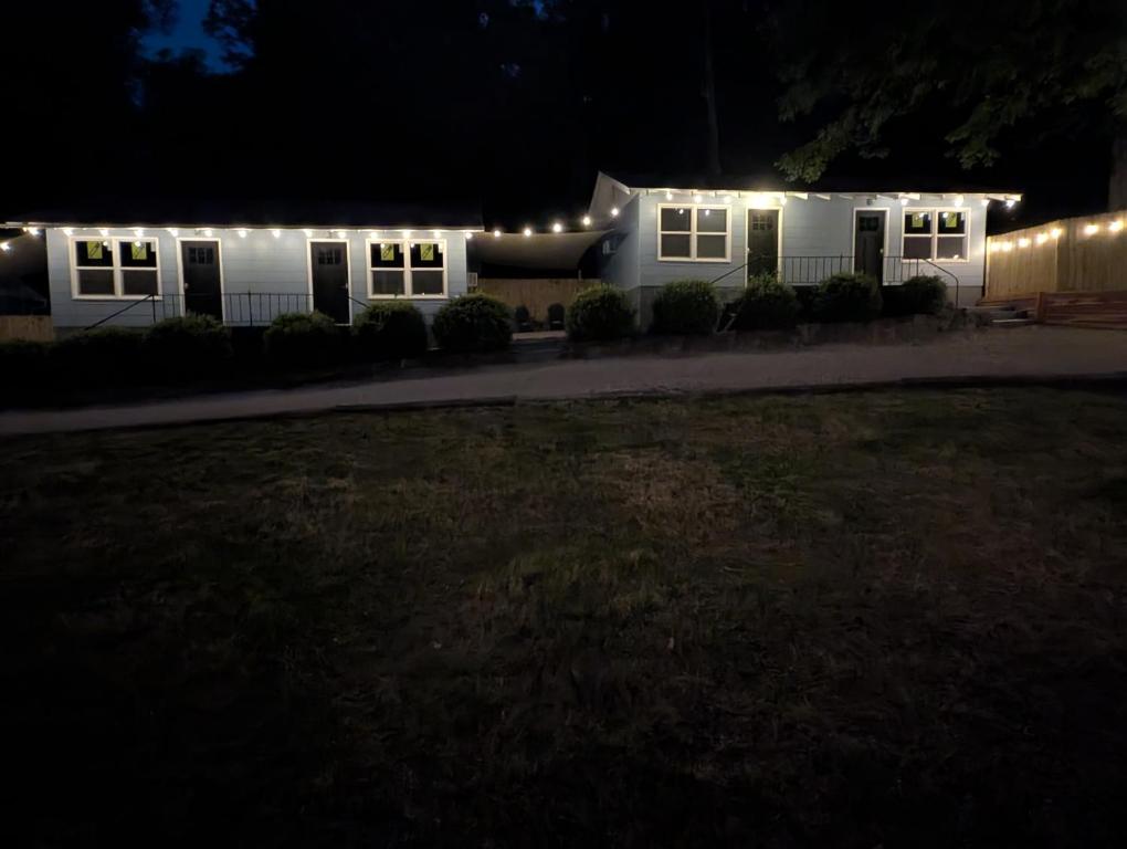 a white house with lights on it at night at Lazy Bull Cottages in Bull Shoals