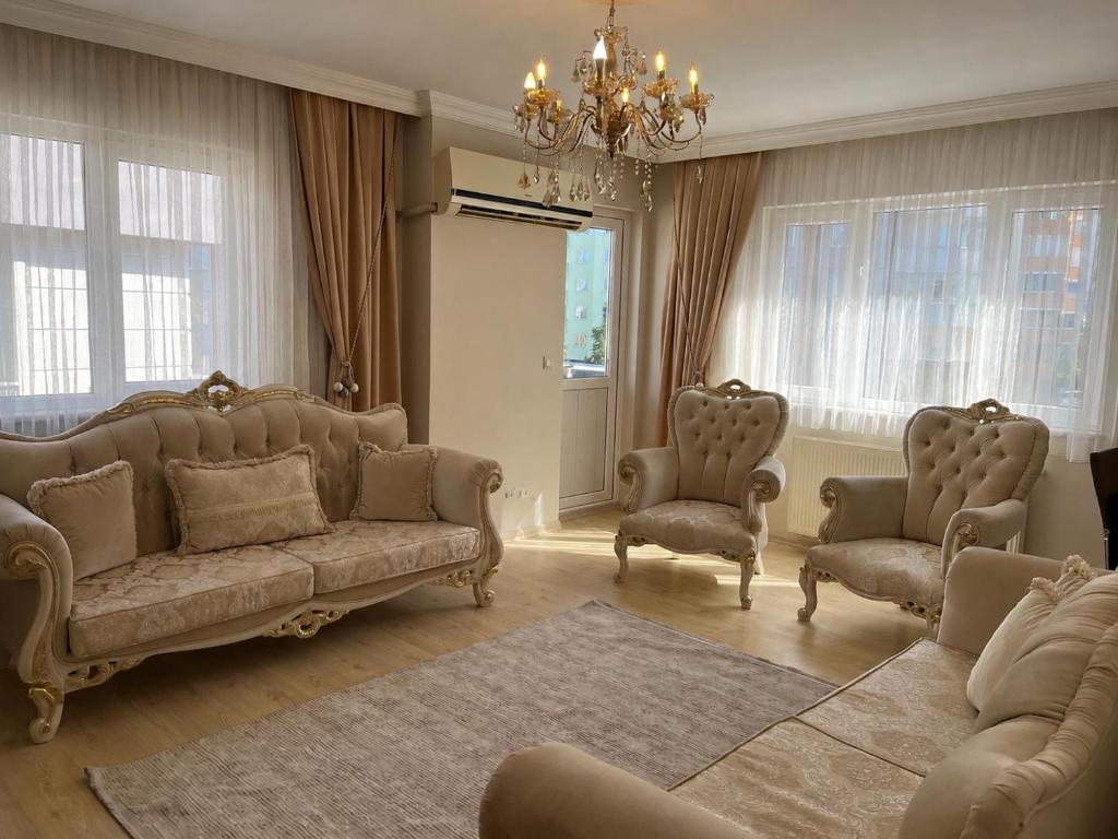 a living room with a couch and chairs and a chandelier at Lale Residence in Trabzon