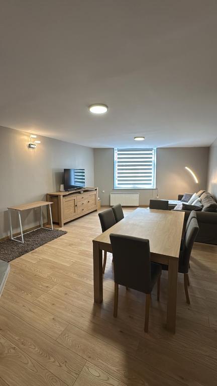 a living room with a table and a couch at Superbe Duplex T2 62m2 - Rénové à Neuf ! in Croix