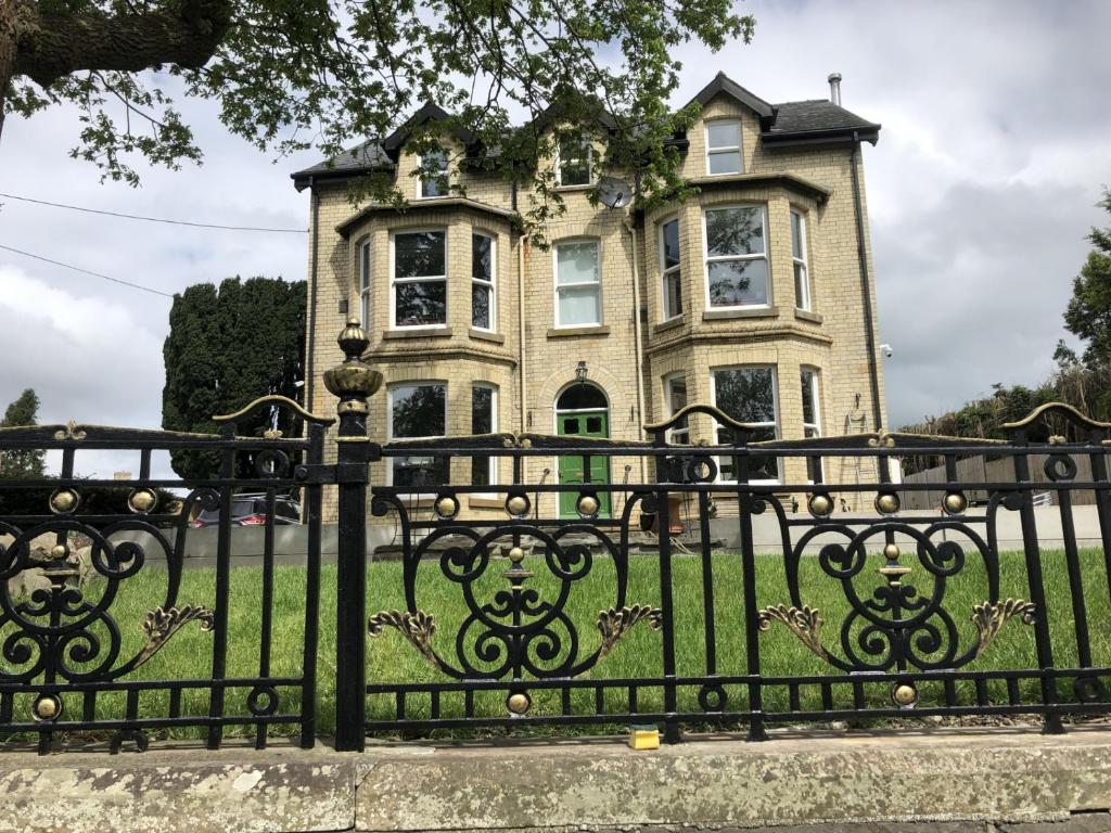a black iron fence in front of a house at Martris House in Rhayader