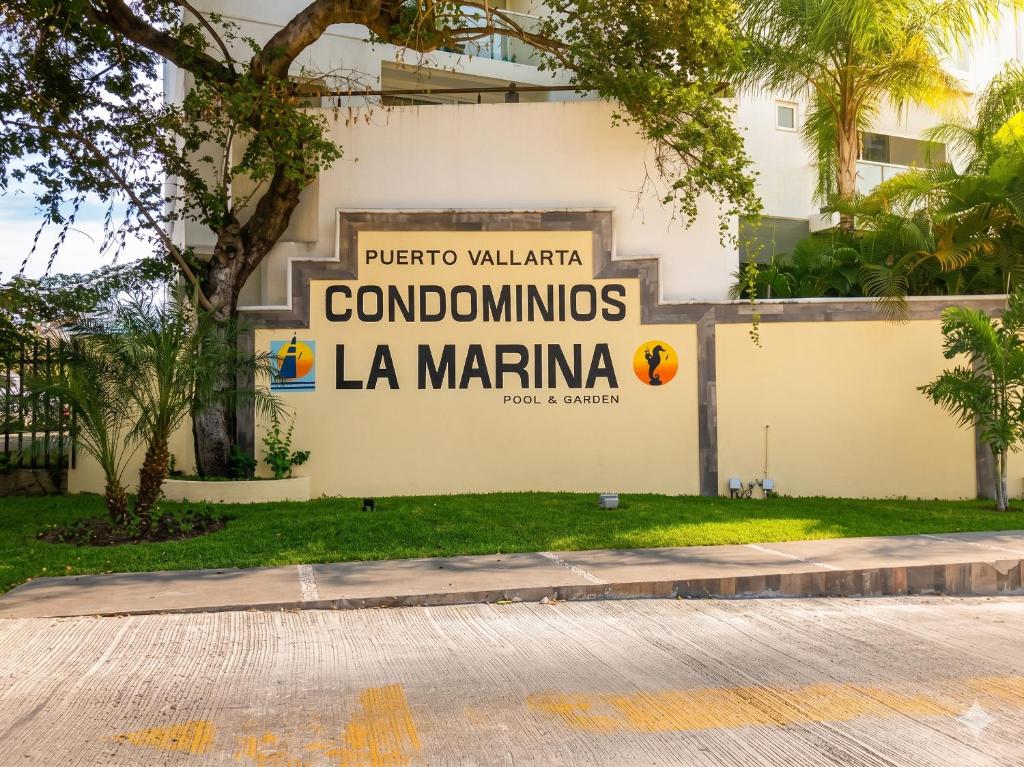 a sign on the side of a building at La Marina Condominiums by Monyxbnb in Puerto Vallarta