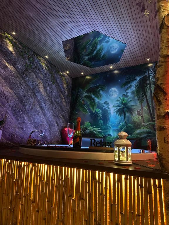 a bar with a tropical mural on the wall at Moonlight Jungle Suit Luxury experience in Avola