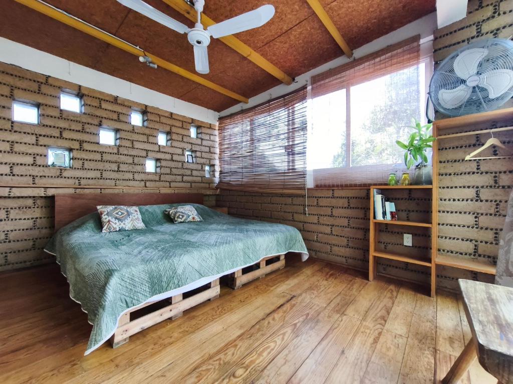 a bedroom with a bed in a brick wall at Casa Santi Tepoztlán in Tepoztlán