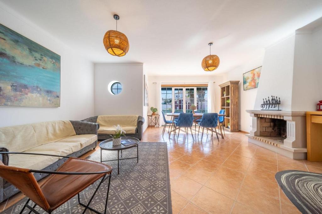 a living room with a couch and a table at Quinta da Mina 13 in Azambuja