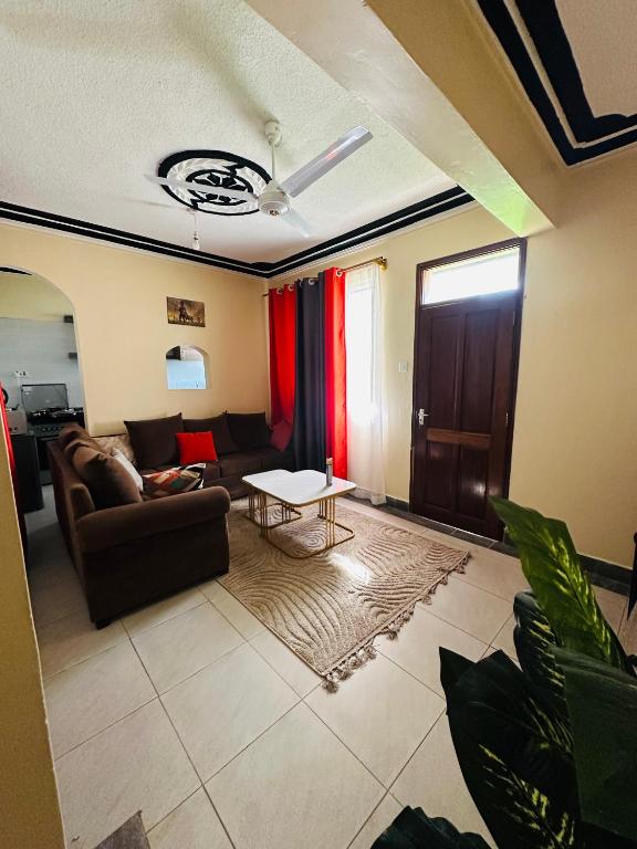 a living room with a couch and a table at Honed homes in Mombasa