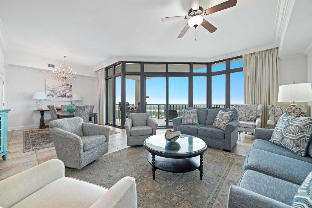 a living room with a couch and chairs and a table at The Oasis at Orange Beach Unit 1816 in Orange Beach