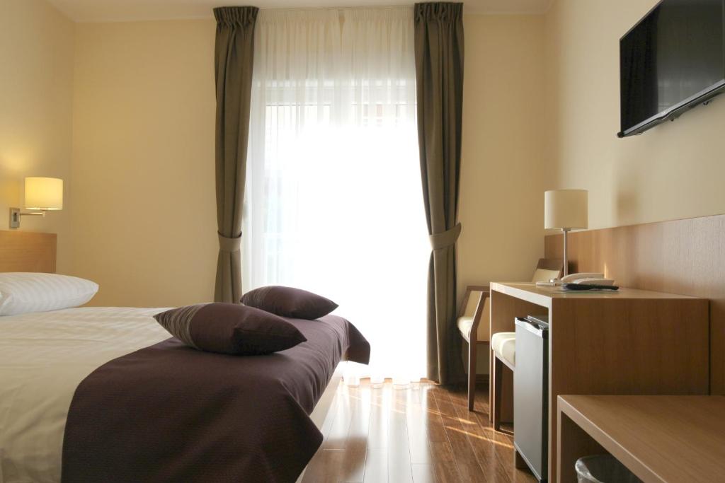 Postel nebo postele na pokoji v ubytování Hotel Villa Privileggio