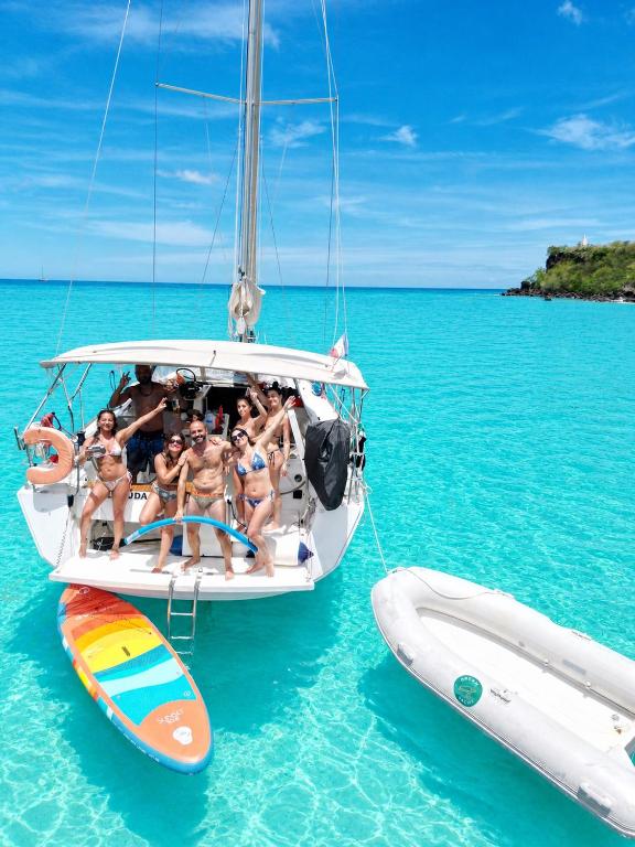 a group of people sitting on a boat in the ocean at Voilier Bermuda By Villa AGADA in Gourbeyre