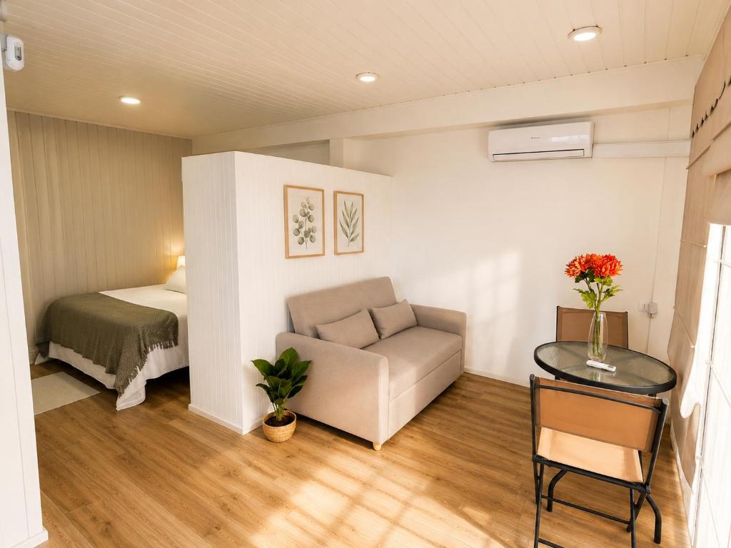 a small living room with a couch and a bed at Loft y Parking Centro de Melipilla in Melipilla