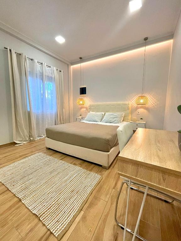 a bedroom with a bed and a large window at Elia Room & Garden in Kontokali
