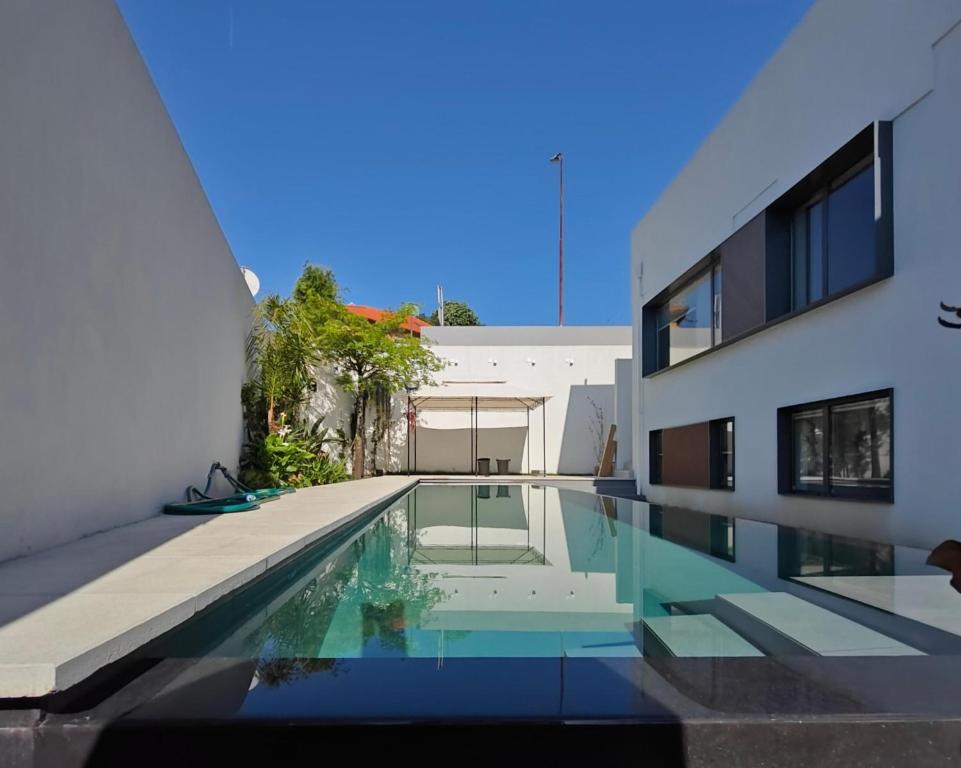 a house with a swimming pool next to a building at Moderninfluence - Aparthotel in Porto