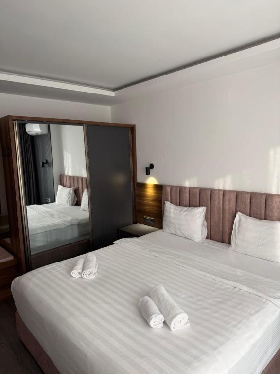 a bedroom with two beds with white towels on them at Batumi View Luxury in Adliye
