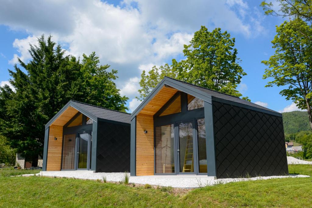 a house with a black roof at Domovi Gorjanke - Gorjanka homes in Ajdovščina