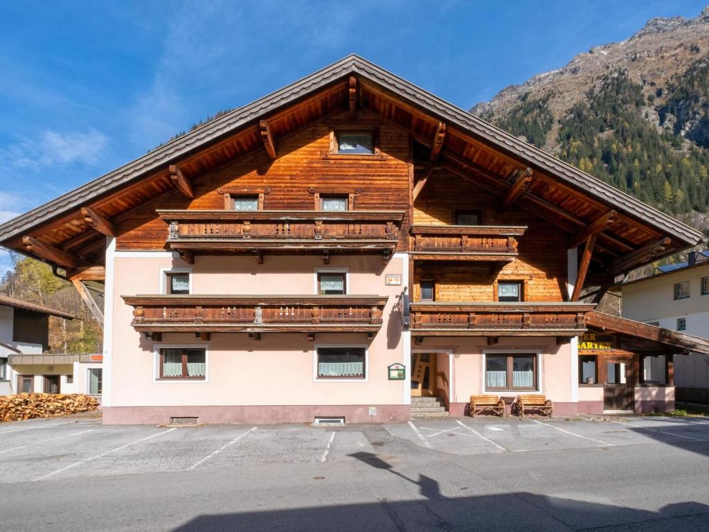 a large building with a wooden roof at Bergheimat L in Huben